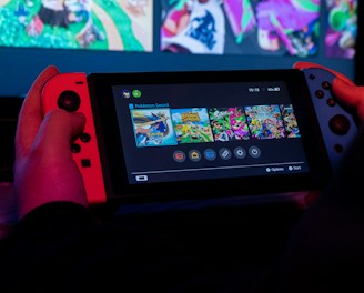 a person holding a nintendo wii game controller