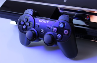 black Sony PS2 controller on white surface