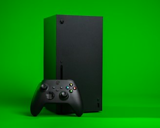 black xbox one console with controller